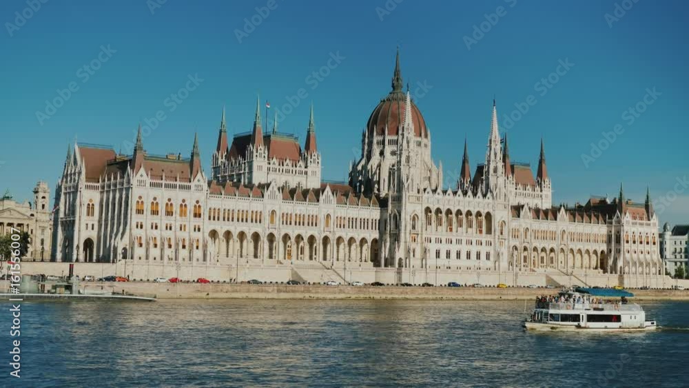 A tourist boat sails on the Danube against the background of the Hungarian Parliament building in Budapest A tourist boat sails on the Danube against the background of the Hungarian Parliament building in Budapest
