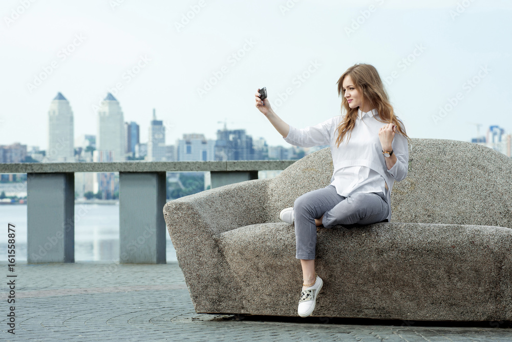 trendy young woman taking a selfie in the city10