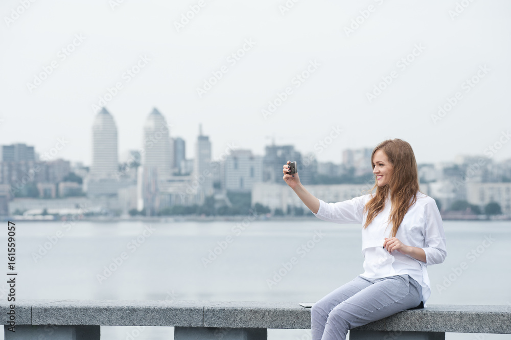 trendy young woman taking a selfie in the city11