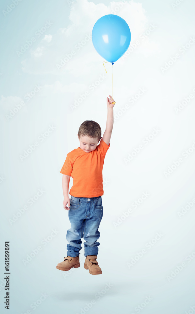 Little boy flies on blue balloon on light blue background