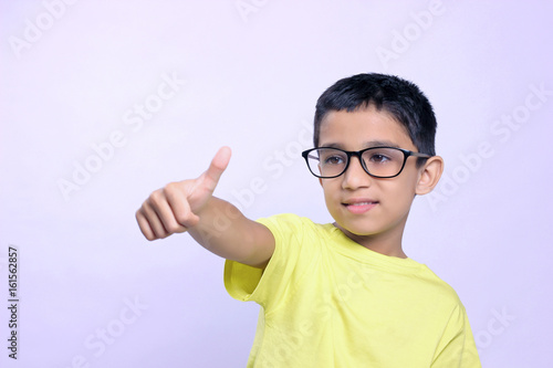 Indian child wear eyeglass and showing thumps up