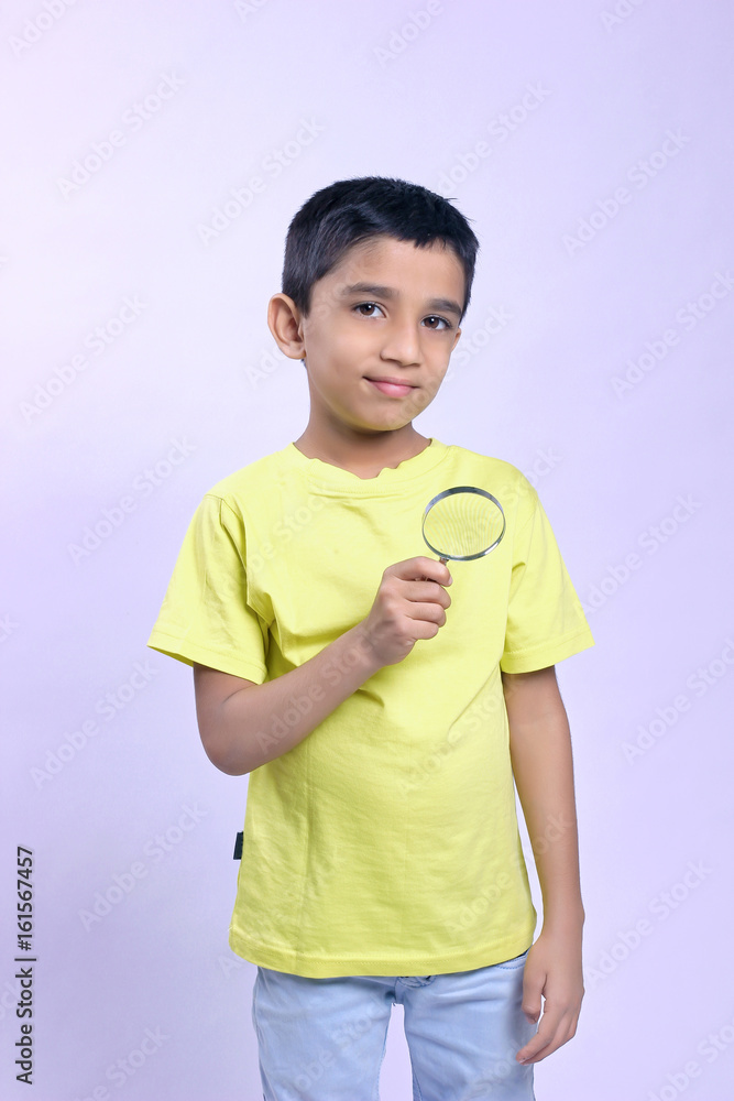 little indian boy holding magnifying glass little indian boy holding magnifying glass
