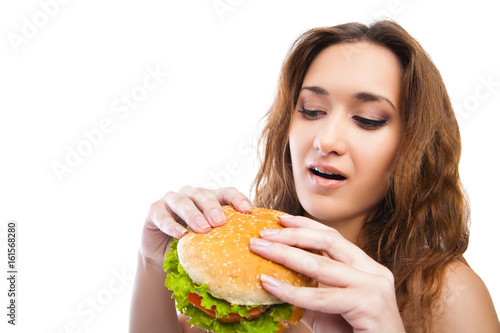 Happy Young Woman Eating big yummy Burger isolated on white background