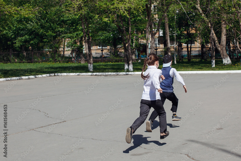 Group of elementary school kids running at school Group of elementary school kids running at school