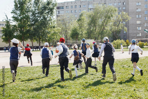 Group of elementary school kids running at school