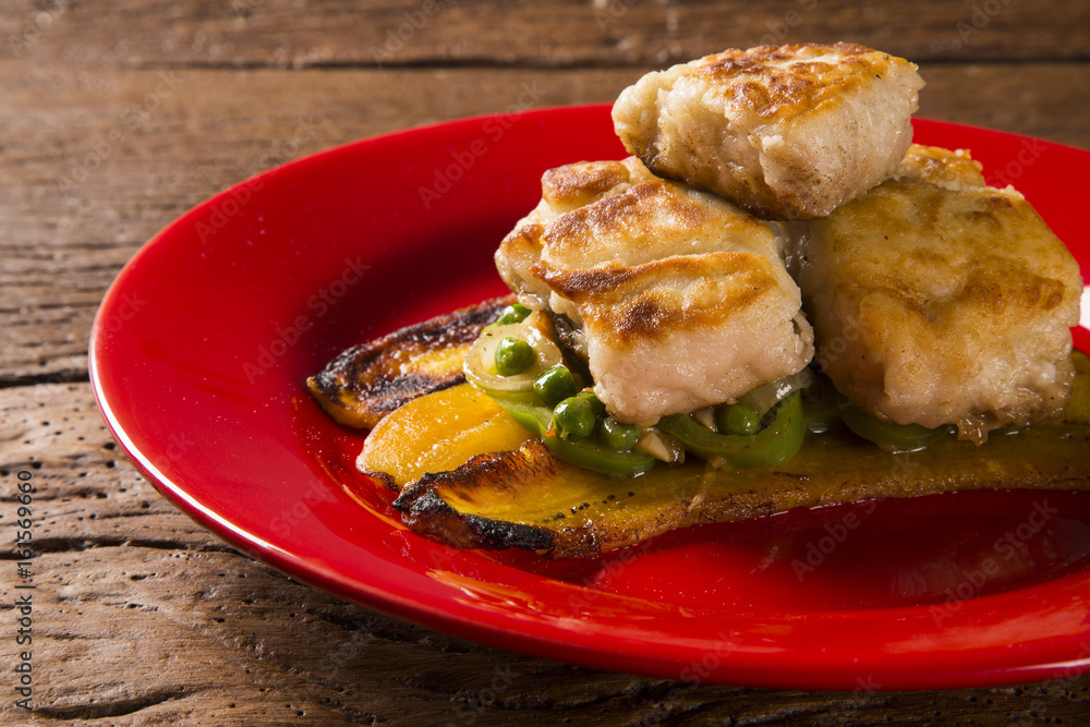 Tucunare fish in butter with green peppers and banana - Traditional Amazonian dish Tucunare fish in butter with green peppers and banana - Traditional Amazonian dish