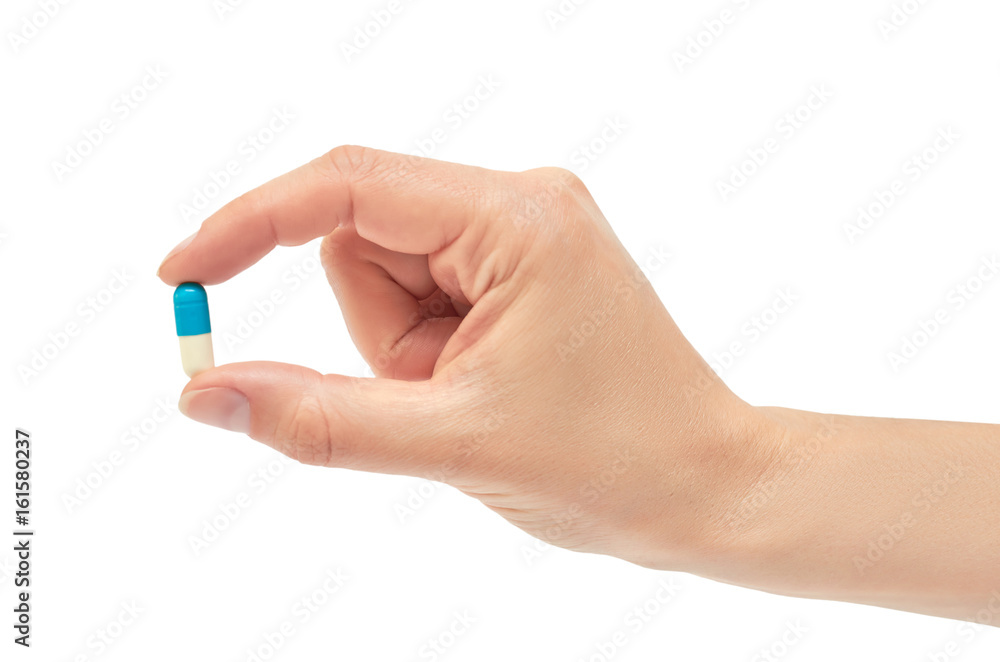 Beautiful female hand holds pill gesture. Isolated on white background Beautiful female hand holds pill gesture. Isolated on white background