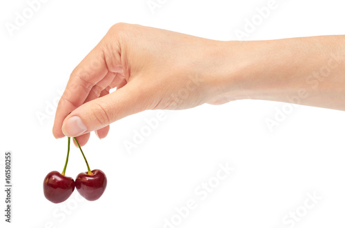 Beautiful female hand holds cherry gesture. Isolated on white background
