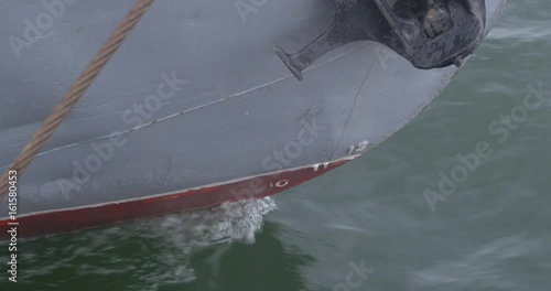 The nose of the ship is close up. Sea liner or cargo ship fixed with a rope or moored to a harbor berth. The yacht's nose close up. Detail of bow nose of fishing boat photo