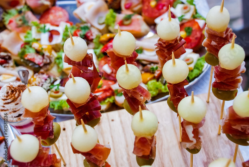 Catering banquet table with different food snacks and appetizers