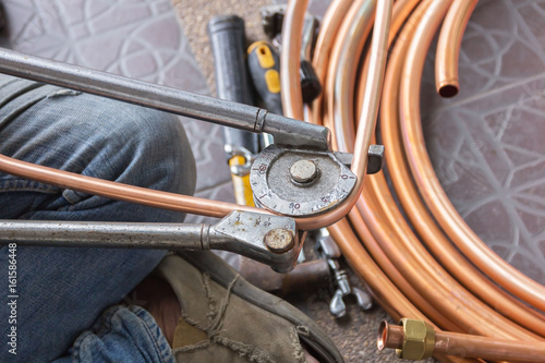 Fototapeta Air mechanic is working to fix the air conditioner.