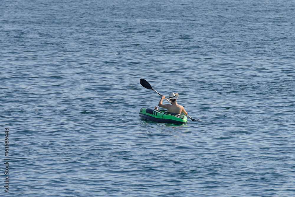young man canoeing in the sea