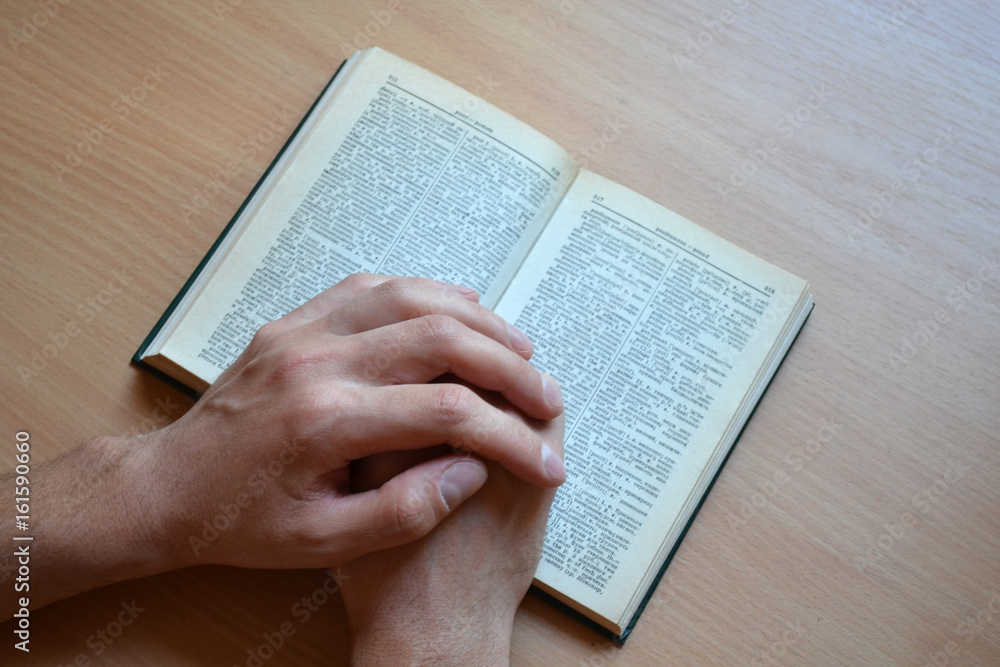 Naklejka premium hands on a book