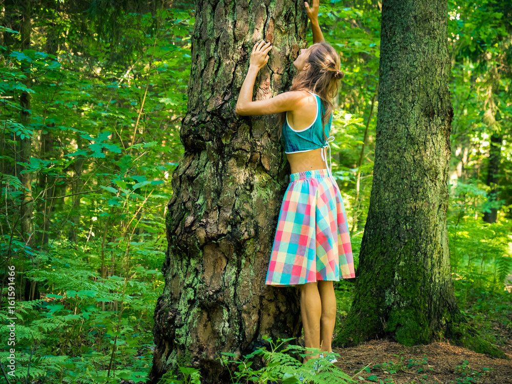 Girl Hugging a Tree in a Forest