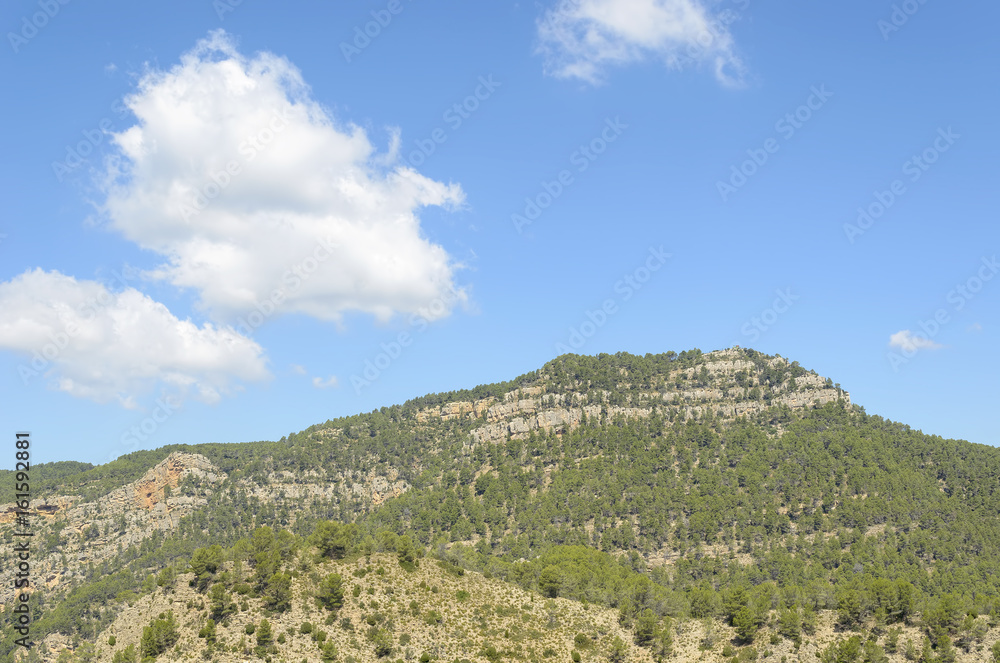 Summit - Morron de Campos - (963 meters of altitude), located in the town of Montanejos, inside the province of Castellon (Valencia - Spain). Natural and beautiful landscape. Blue sky with clouds