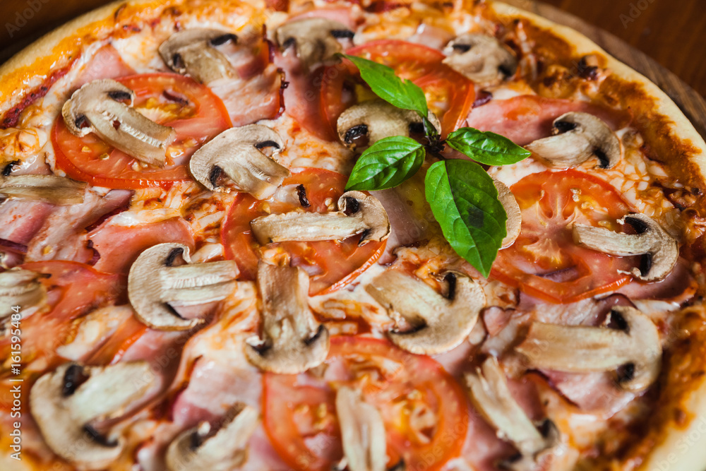 Delicious pizza with meat, cheese and mushrooms Delicious pizza with meat, cheese and mushrooms