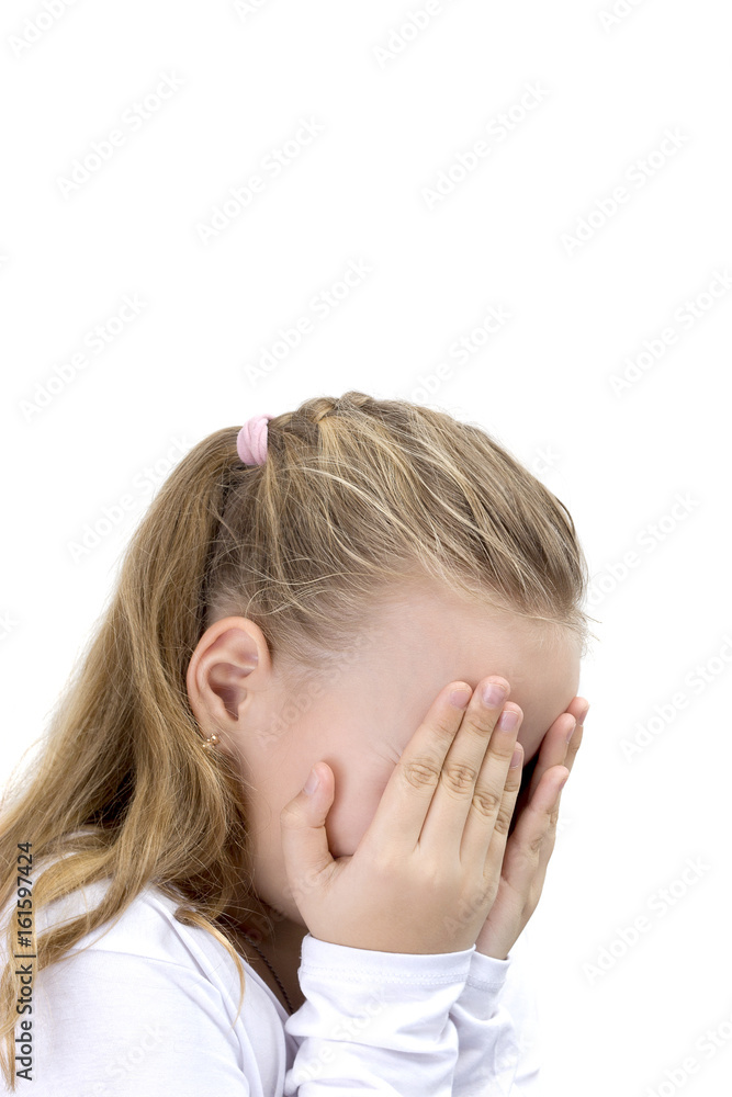 Child covering her face with her hands. Blonde little girl covers her face with her hands isolated. Girl hide face under hands, playing hide-and-seek. Child covering her face with her hands. Blonde little girl covers her face with her hands isolated. Girl hide face under hands, playing hide-and-seek.