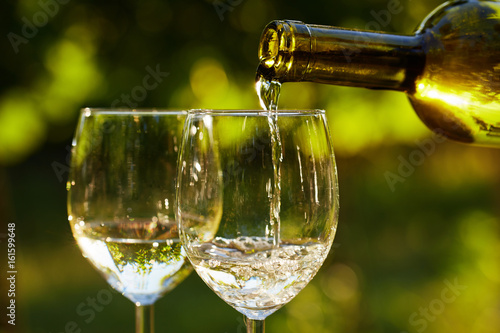 Two glasses of white wine on table