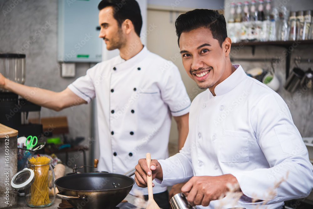 Chef preparing food in the kitchen of a restaurant Chef preparing food in the kitchen of a restaurant