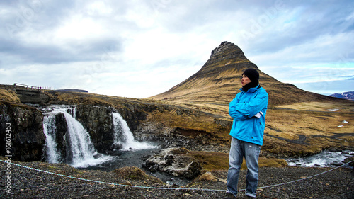 Asian man at iconic mountain Kirkjufell of Iceland. Once in a life time goal