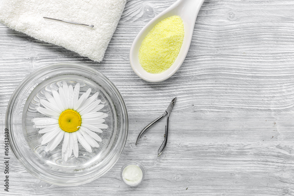 hands care set for manicure with chamomile on gray wooden background top view space for text hands care set for manicure with chamomile on gray wooden background top view space for text