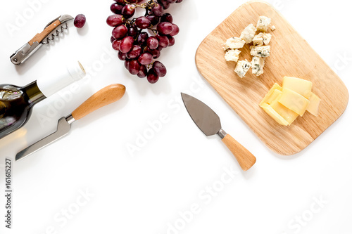Valokuva Bottle of red wine with cheese and grape aperitive on white background space for