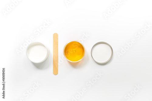 Wax and stick for depilation on white background top view copyspace