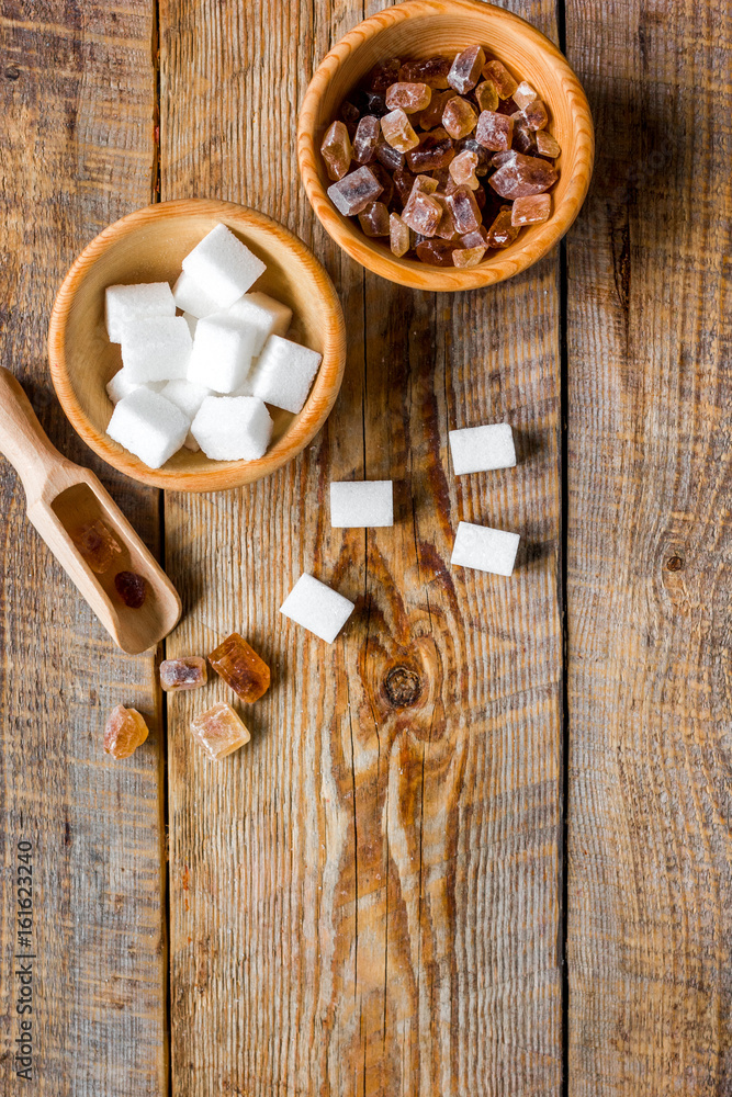 Fototapeta premium variety of sugar in bowls on wooden table background top view space for text