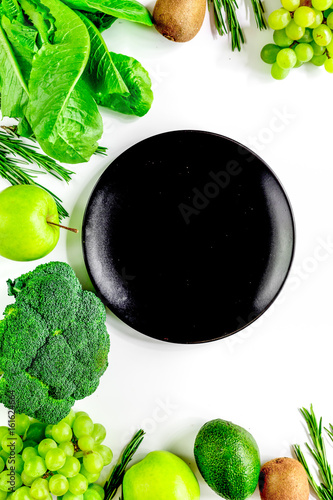 organic food for homemade salad with green vegetables and plate white desk background top view mock-up photo