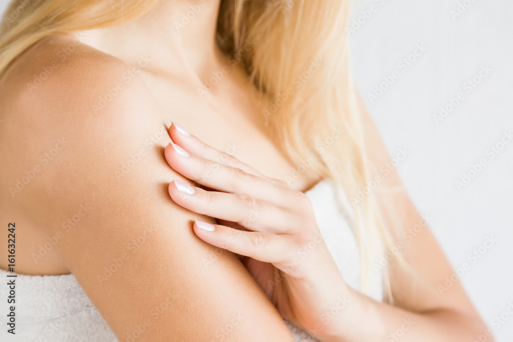 Young woman in towel after shower applying a body cream. Skin care. Young woman in towel after shower applying a body cream. Skin care.