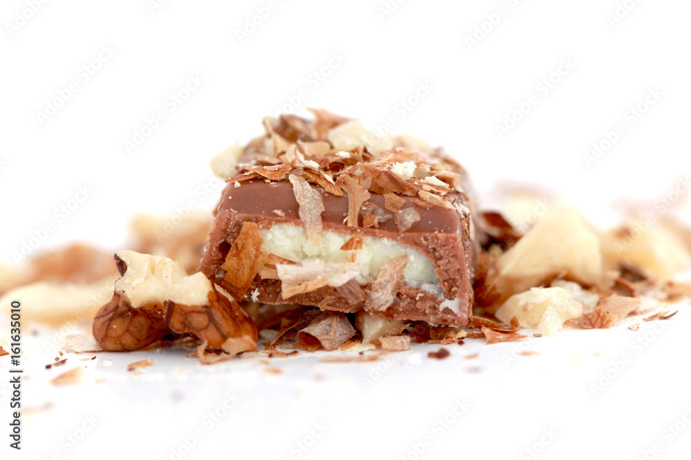 close up a milk chocolate bar and walnuts on white background close up a milk chocolate bar and walnuts on white background