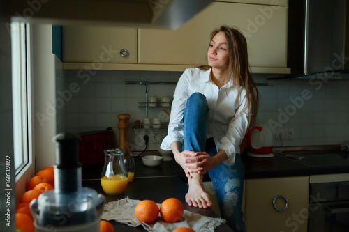 Young woman sitting in the kitchen healthy morning