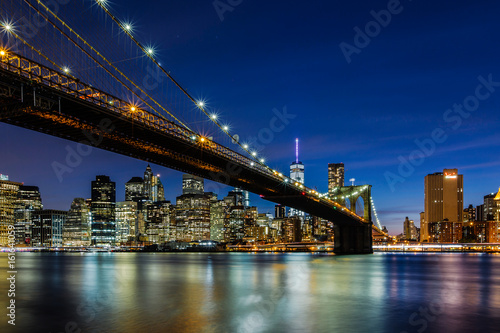 Fototapeta Naklejka Na Ścianę i Meble -  Dusk at Brooklyn Bridge and Lower Manhattan Skyline, New York United States
