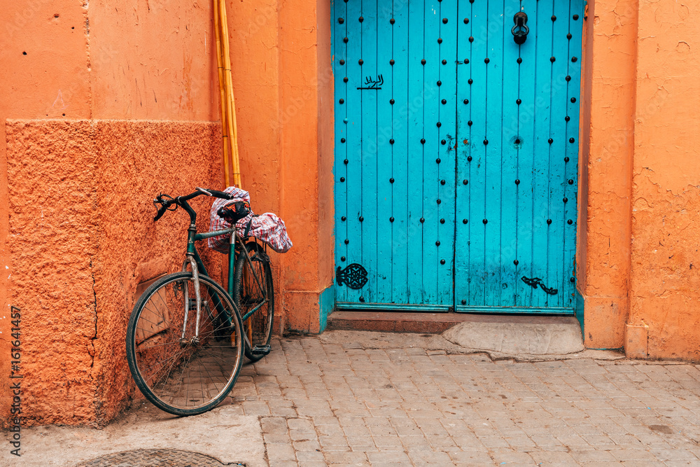 bike standing at marrakech medina wall, morocco