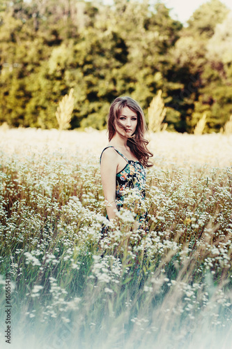 beautiful girl on the flowers field