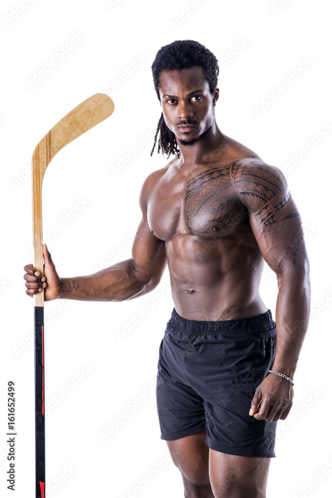 Portrait of a handsome black man posing shirtless for camera with hockey stick in his hands Portrait of a handsome black man posing shirtless for camera with hockey stick in his hands