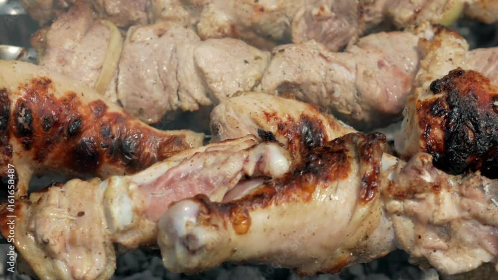 Preparation of meat on charcoal in the street. Chicken and pork are strung on metal pins. Moving camera Preparation of meat on charcoal in the street. Chicken and pork are strung on metal pins. Moving camera
