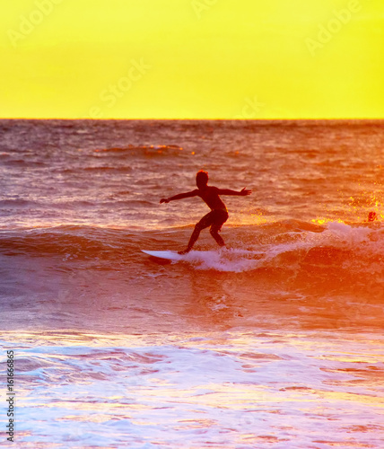 Bali surfing at sunset