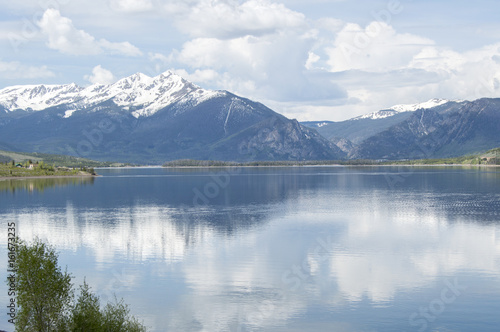 Rocky Mountain Lake with reflection in water and snow capped peaks