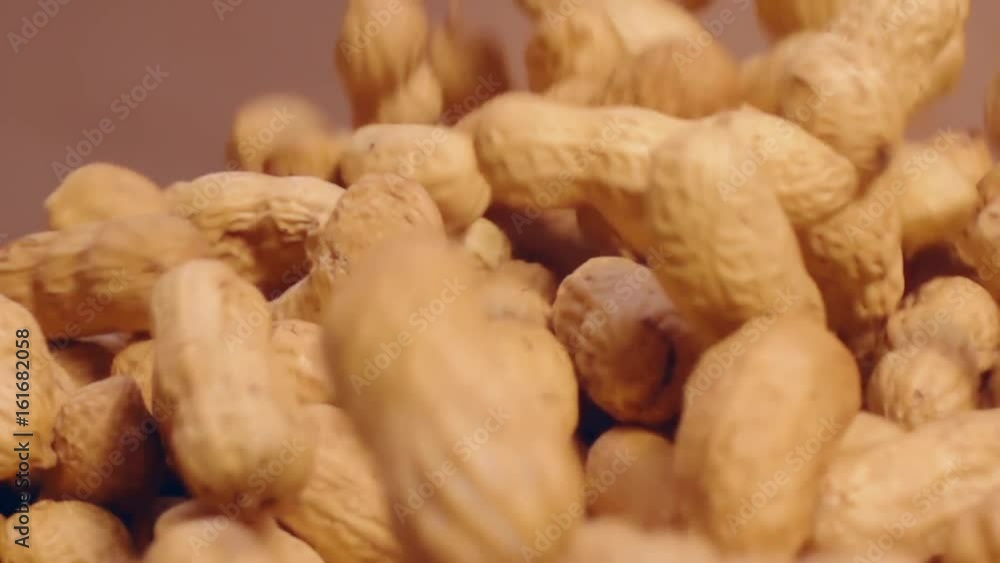 Peanuts fall on a soft surface in super slow motion Peanuts fall on a soft surface in super slow motion