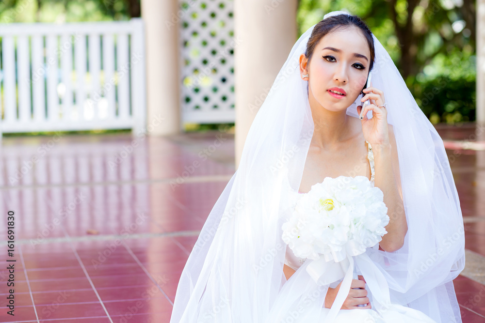 bride talking on cell phone in wedding dress bride talking on cell phone in wedding dress