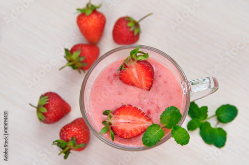 A glass of smoothies with strawberries and mint