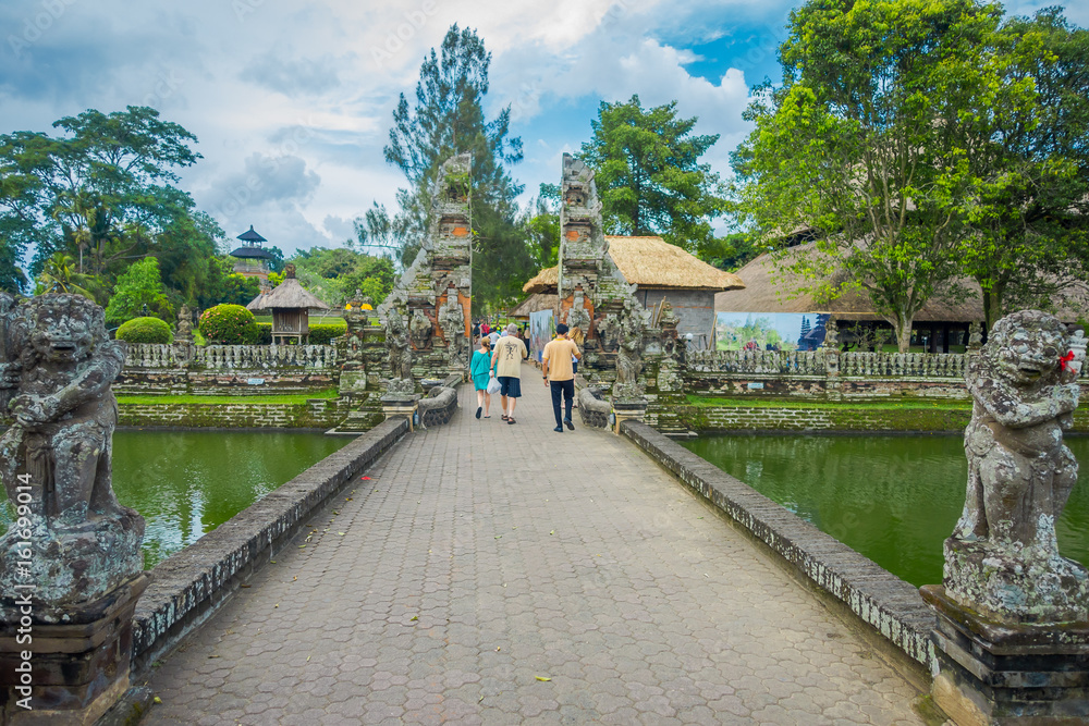 People walking inside of the temple of Mengwi Empire located in Mengwi, Badung regency that is famous places of interest in Bali, Indonesia People walking inside of the temple of Mengwi Empire located in Mengwi, Badung regency that is famous places of interest in Bali, Indonesia