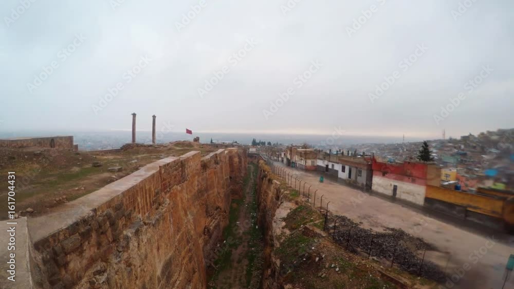 Ditch of Urfa Castle Divides Ruins and Slum Far Two Columns Birds Fly Snow and Rain Panorama Ditch of Urfa Castle Divides Ruins and Slum Far Two Columns Birds Fly Snow and Rain Panorama