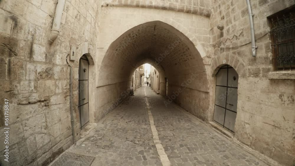 Arche From Overbuilt Passage Under Narrow Ancient Street Paved With Stones in Urfa Arche From Overbuilt Passage Under Narrow Ancient Street Paved With Stones in Urfa