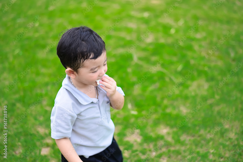 Little Asian kid at the playground under the sunlight, shallow DOF Little Asian kid at the playground under the sunlight, shallow DOF
