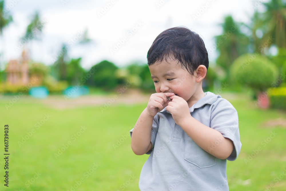 Little Asian kid at the playground under the sunlight, shallow DOF Little Asian kid at the playground under the sunlight, shallow DOF