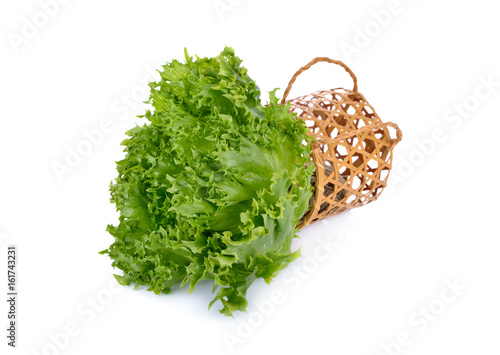 fresh green frilly iceberg lettuce with bamboo basket on white background