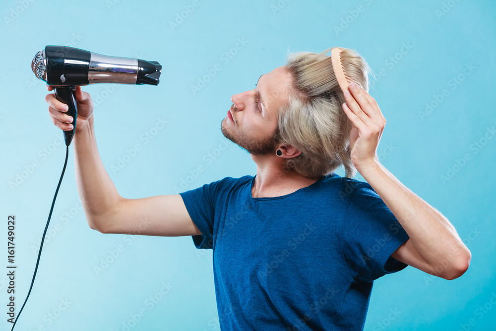 Trendy man with hair dryer Trendy man with hair dryer