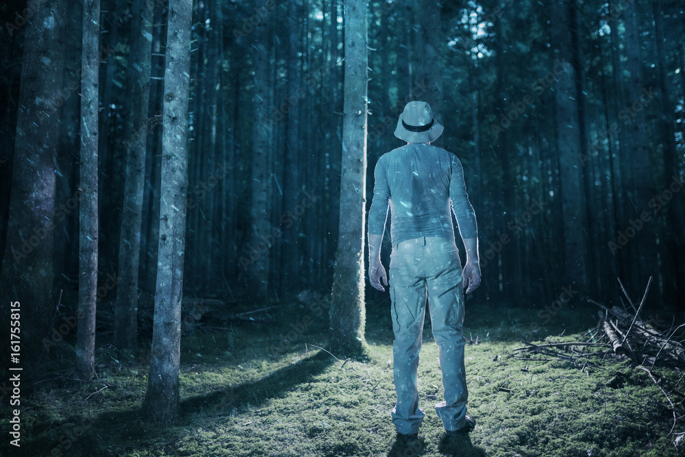 Exhausted men standing in the rainy evening woods. Exhausted men standing in the rainy evening woods.